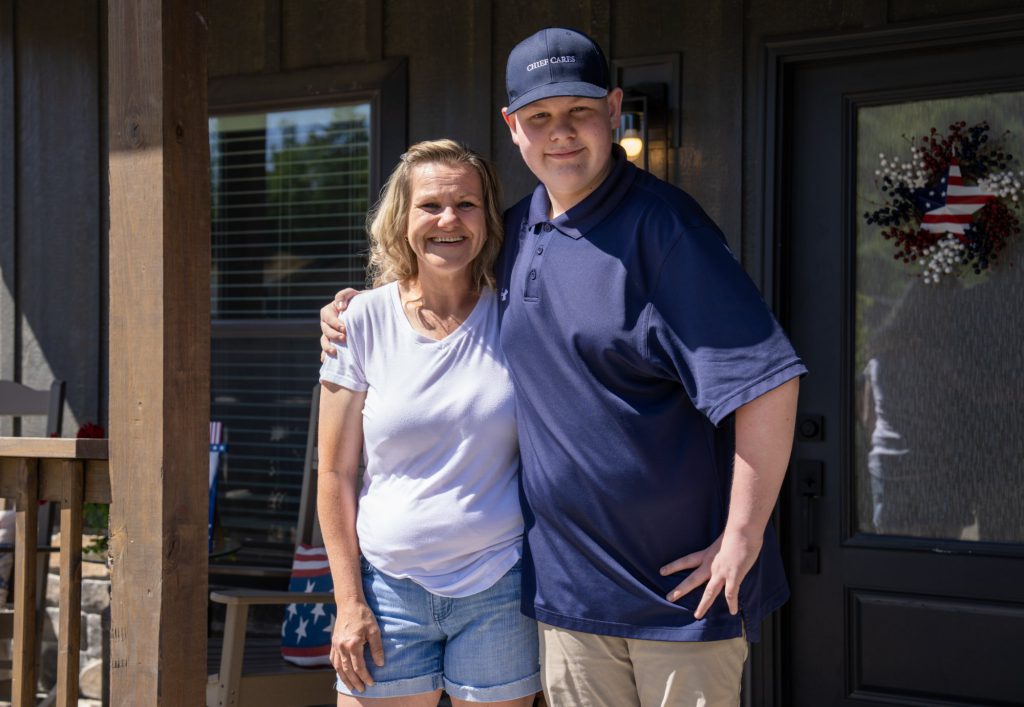 A Blue Haven resident and her son on their porch
